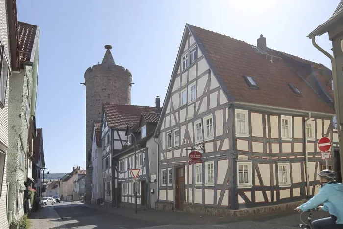 Framed Print : Historic Leonhard Tower built in 1386 and half-timbered house in Fuldauer Gasse