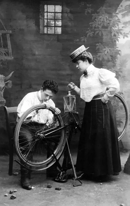 Framed Print : Historic photograph, man repairing a woman's bicycle