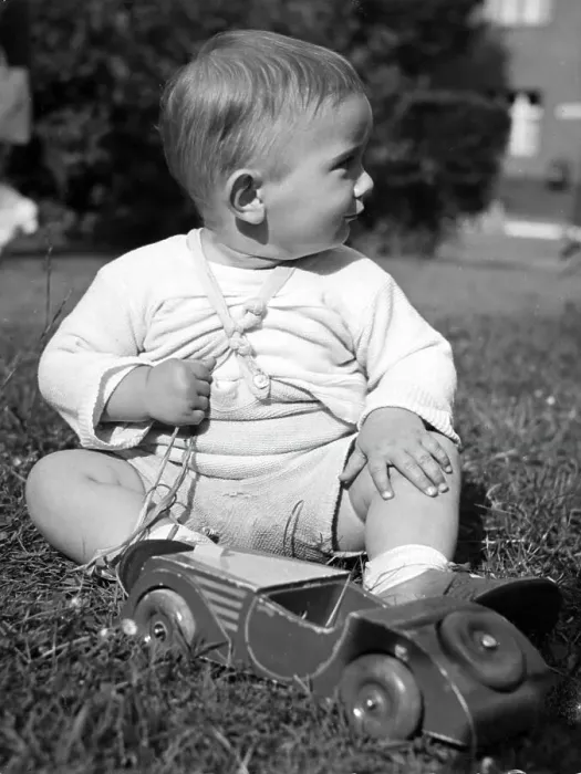 Framed Print : Historic photograph, small boy playing with a wooden car