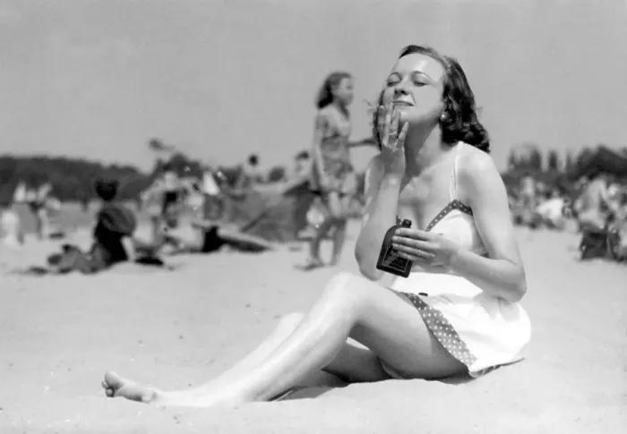 Framed Print : Historic photograph, woman at the beach applying suncream