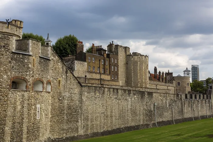 Framed Print : Historic stone walls of a fortification under a cloudy sky at The Tower of London