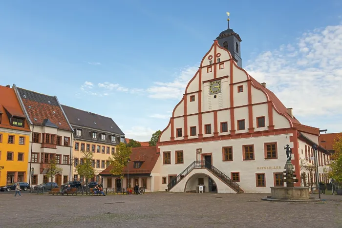 Framed Print : Historic town hall with clock tower on a cobbled square under a blue sky in an old town Framed Print : Historic town hall with clock tower on a cobbled square under a blue sky in an old town