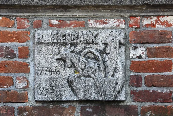 Framed Print : Historical stone relief with a rooster and inscription on a brick wall