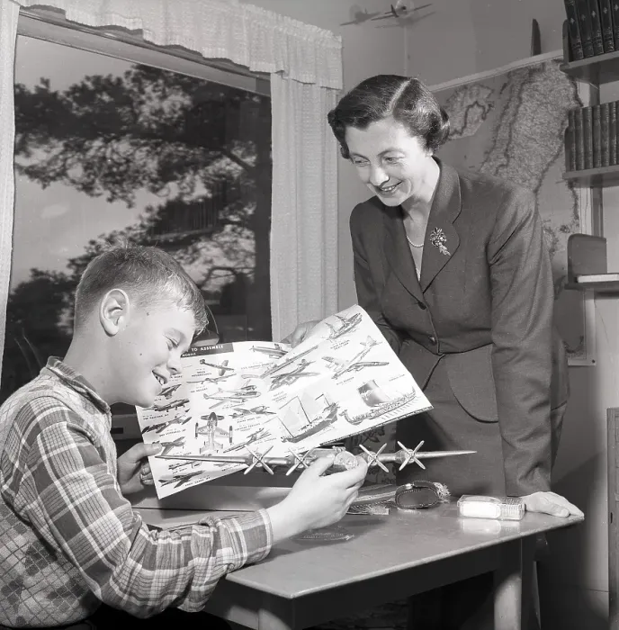 Framed Print : Hobby in the 1950s. A boy is sitting at a table with a plastic model of an American bomb aircraft B29 Framed Print : Hobby in the 1950s. A boy is sitting at a table with a plastic model of an American bomb aircraft B29