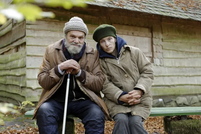 Framed Print : Homeless couple in front of a forest hut