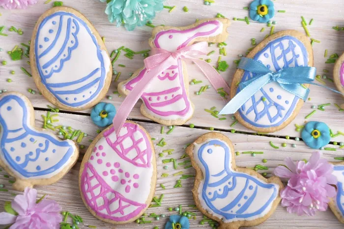 Framed Print : Homemade Easter cookies in shape of eggs chicken and rabbit on white wooden kitchen table flat lay closeup view