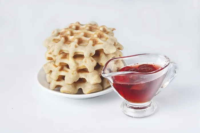 Framed Print : Homemade waffles with strawberry jam on a white background