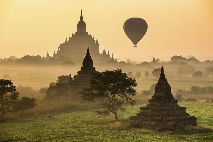 Framed Print : Hot air balloon over the landscape in the early morning fog