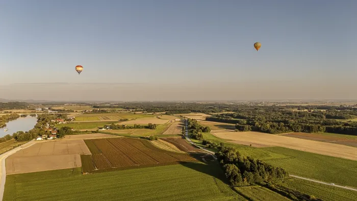 Framed Print : Two hot air balloons float calmly over the wide fields and the Danube (Lower Bavaria)