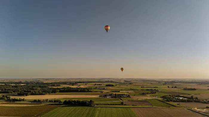 Framed Print : Two hot-air balloons float majestically over the rolling hills