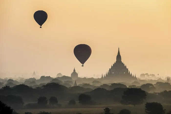 Framed Print : Hot air balloons over the landscape in the early morning fog