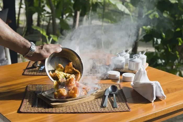 Framed Print : A hot plate with Thai food being served