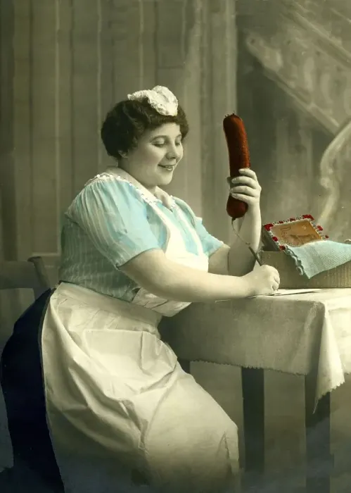 Framed Print : Housekeeper writes a letter with a big sausage in her hand