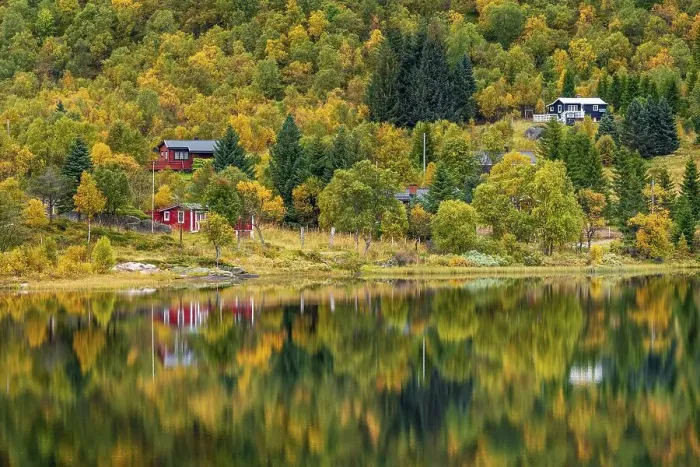 Framed Print : Houses in autumnal forest reflected in the lake Framed Print : Houses in autumnal forest reflected in the lake