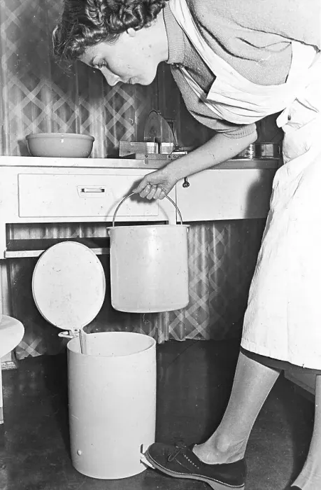 Framed Print : Housewife empties the trash can, ca Framed Print : Housewife empties the trash can, ca