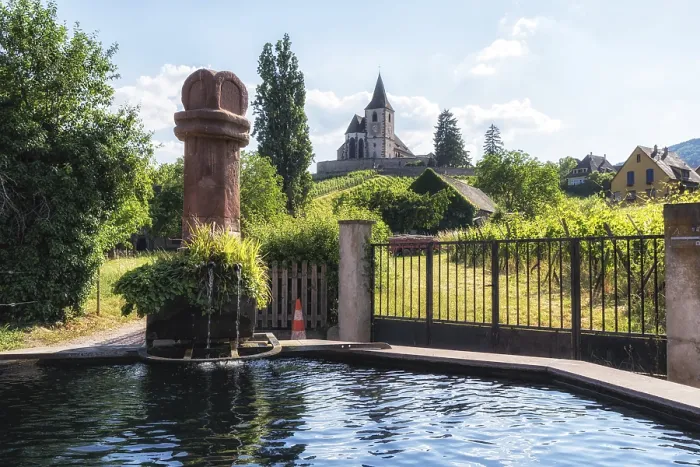 Framed Print : Hunawihr saint hune fountain and old fortified church surrounded by vineyards