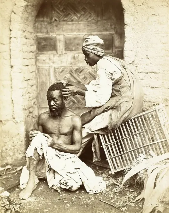 Framed Print : Hunting for Fleas, Man examining the hair of another for fleas and vermin