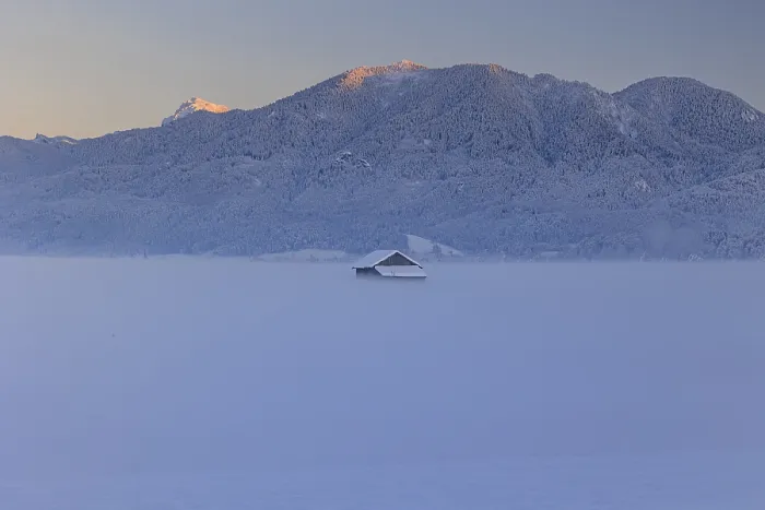 Framed Print : Hut in the snow in front of mountains