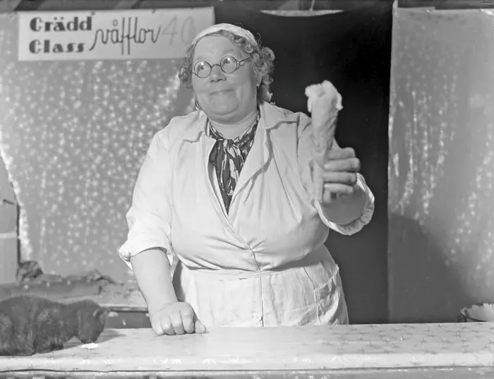 Framed Print : Ice cream in the 1940s. The woman selling ice cream is handing holding cone of vanilla ice cream