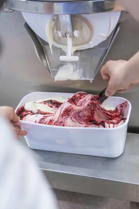 Framed Print : Ice cream is scraped out of a machine