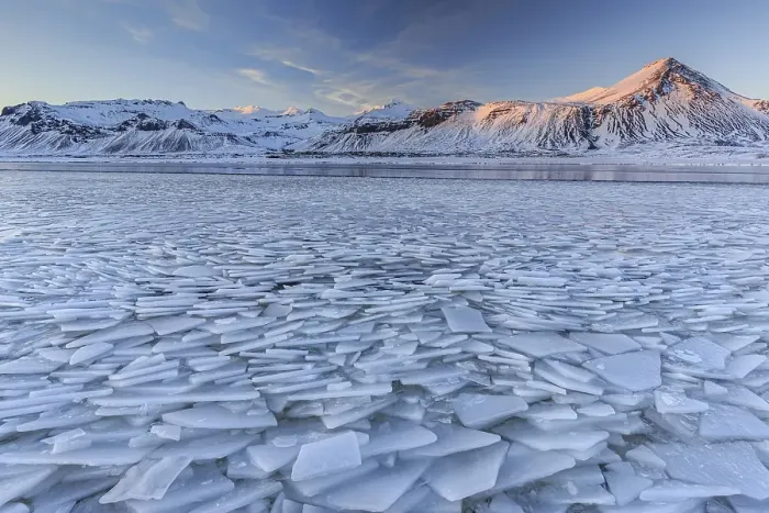 Framed Print : Ice floes on a lake in front of snowy mountains Framed Print : Ice floes on a lake in front of snowy mountains