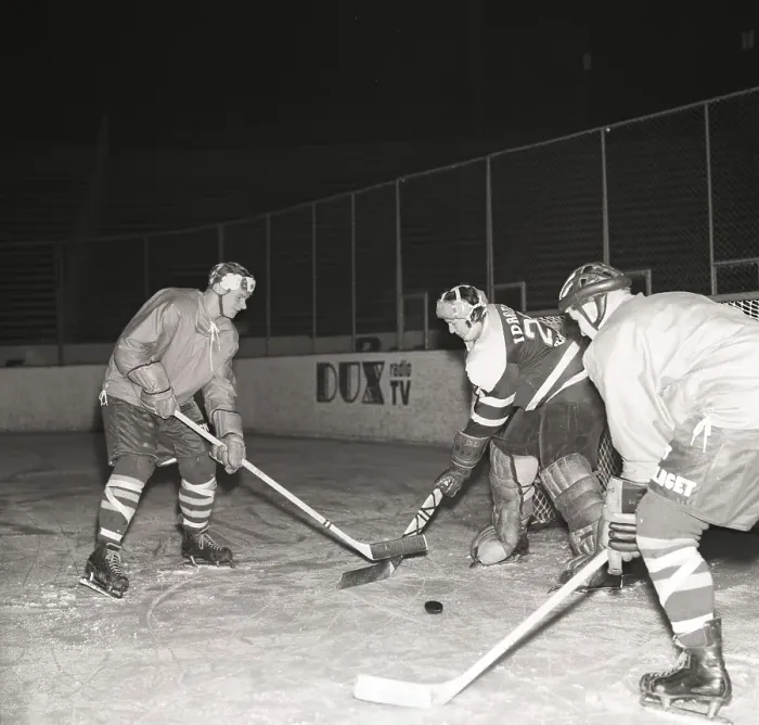 Framed Print : Ice hockey in the 1950s. A goalkeeper and two players on the ice hockey rink Framed Print : Ice hockey in the 1950s. A goalkeeper and two players on the ice hockey rink