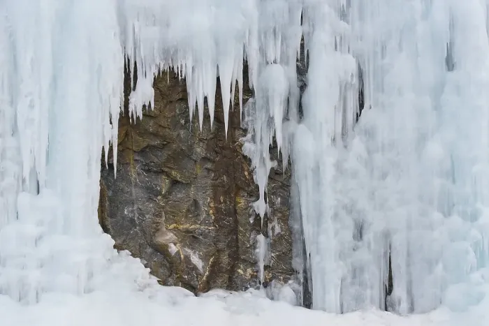 Framed Print : Icicles in front of a rock face