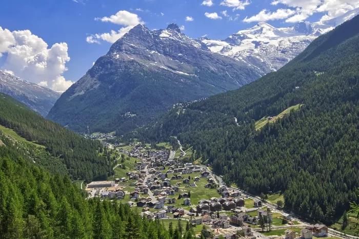 Framed Print : An idyllic Alpine village nestled in a green valley