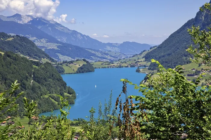 Framed Print : Idyllic landscape with blue lake in a valley surrounded by mountains under a clear sky