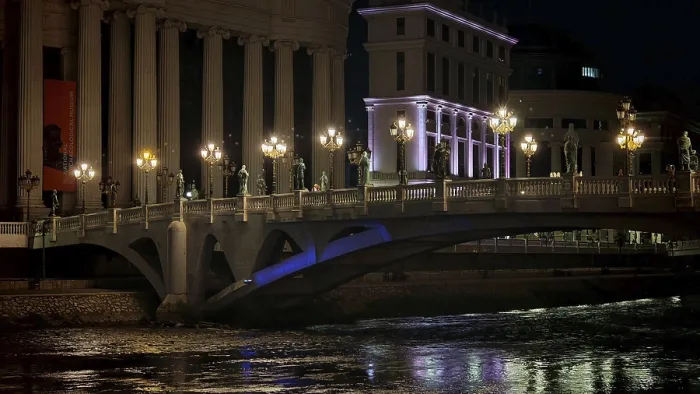 Framed Print : Illuminated bridge over a river at night with urban architecture in the background Framed Print : Illuminated bridge over a river at night with urban architecture in the background