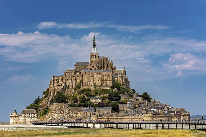 Framed Print : An imposing castle rises against a blue sky with a few clouds Framed Print : An imposing castle rises against a blue sky with a few clouds