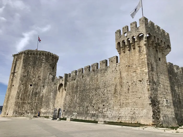 Framed Print : Imposing medieval stone castle with fortified walls and flags Framed Print : Imposing medieval stone castle with fortified walls and flags