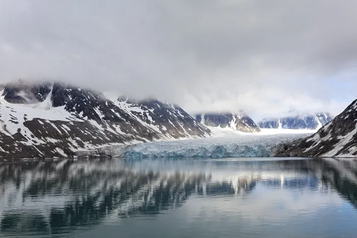 Framed Print : An impressive lake reflects the surrounding glaciers and mountains