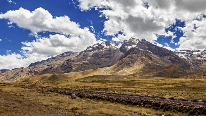 Framed Print : Impressive mountain range with snowy peaks under a cloudy blue sky