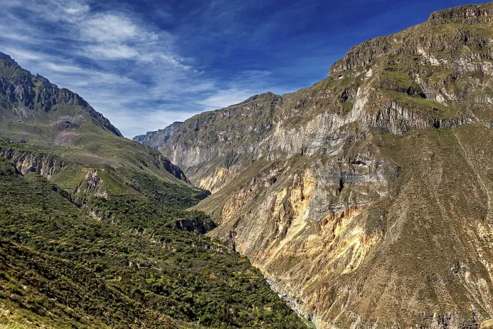 Framed Print : Impressive rock cliffs stretch across a green valley