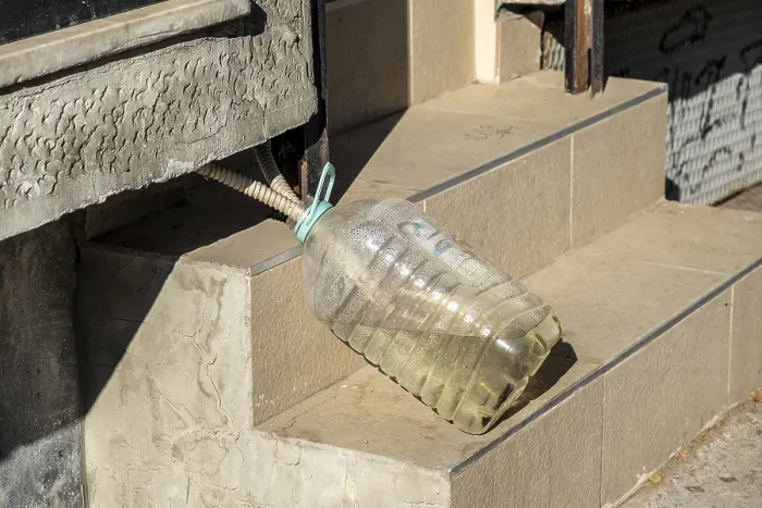 Framed Print : Improvised water drainage with plastic bottle on stairs