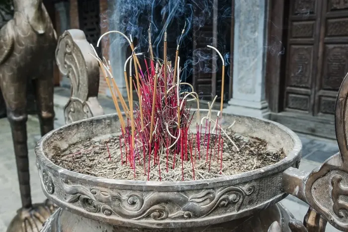 Framed Print : Incense sticks burning in a container in front of a Buddhist temple at Trang An Grottoes in the Trang An Scenic Framed Print : Incense sticks burning in a container in front of a Buddhist temple at Trang An Grottoes in the Trang An Scenic