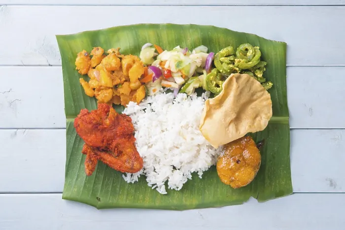 Framed Print : Indian banana leaf rice, overhead view on wooden dining table