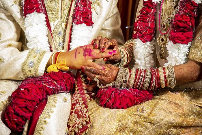 Framed Print : Indian bride passing wedding ring on her groom's finger on her wedding ceremony