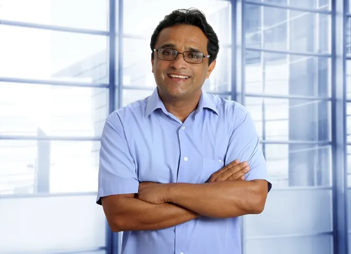 Framed Print : Indian latin businessman with glasses and blue shirt in modern office