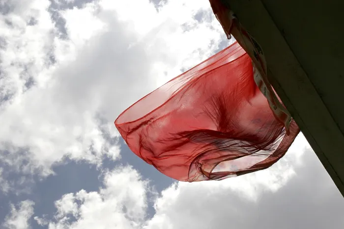 Framed Print : Indian traditional ladies wear saris flying in air against white clouds and blue skies