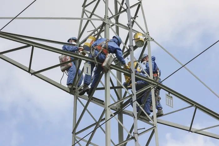 Framed Print : Industrial climber high up on an electricity pylon