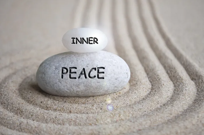 Framed Print : Inner peace text engraved on Zen stone on sand with shining