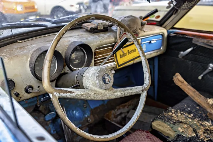Framed Print : Interior of an old car with worn steering wheel and dashboard in retro style