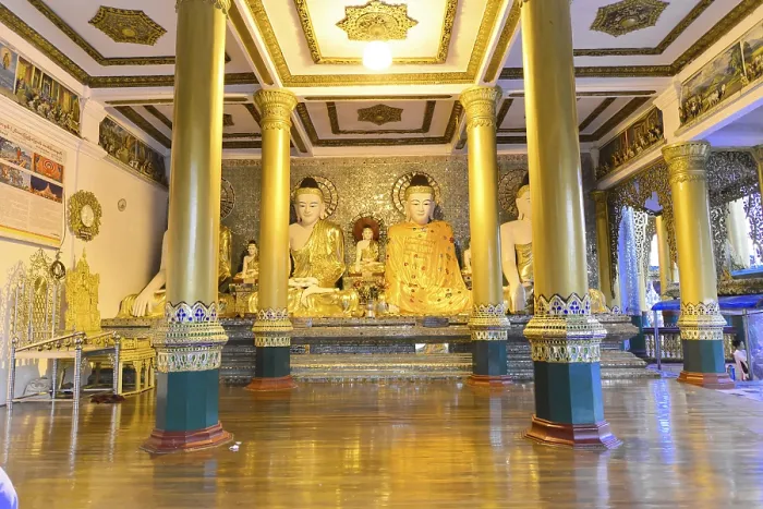 Framed Print : Interior of the temple with golden Buddha statues on a decorated pedestal