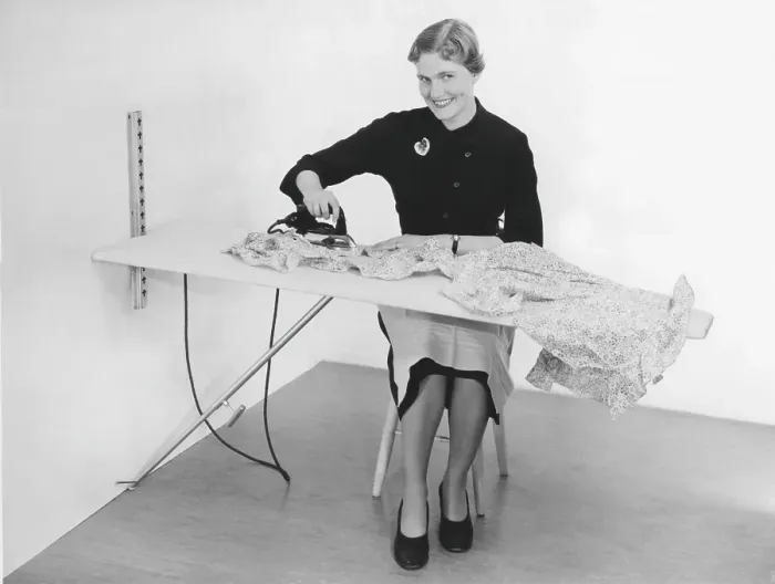 Framed Print : Ironing in the 1950s. A woman seen ironing her clothes. Sweden 1955
