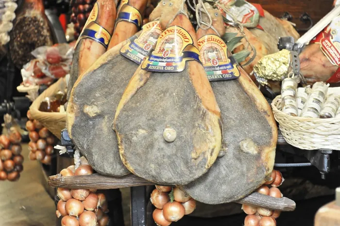 Framed Print : Italian hams and sausages presented in baskets at a market Framed Print : Italian hams and sausages presented in baskets at a market