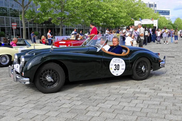 Framed Print : Jaguar XK 140, black convertible with smiling driver at an outdoor classic car event