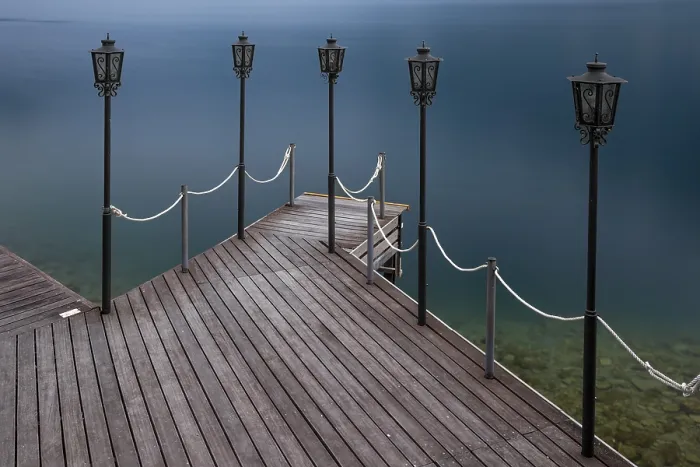 Framed Print : Jetty with lamps jutting out into calm blue water