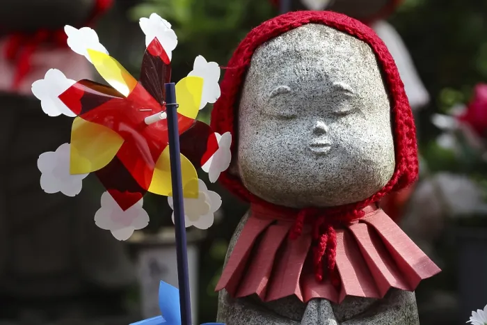 Framed Print : Jizo statue with red cloth and wind turbine at Zojo-ji shrine in Minato Framed Print : Jizo statue with red cloth and wind turbine at Zojo-ji shrine in Minato